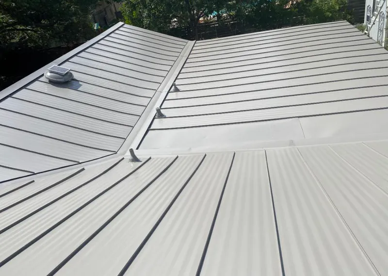 Solar attic fan installed on a metal roof for Roof Ventilation in Manlius